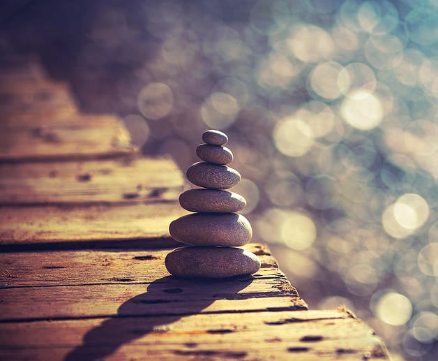 Six small rocks stacked upon each other to demonstrate the concept of Inner Peace and Life in Balance